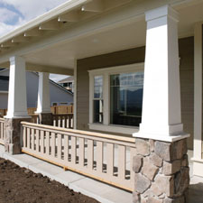 front porch columns with a wood railing systems